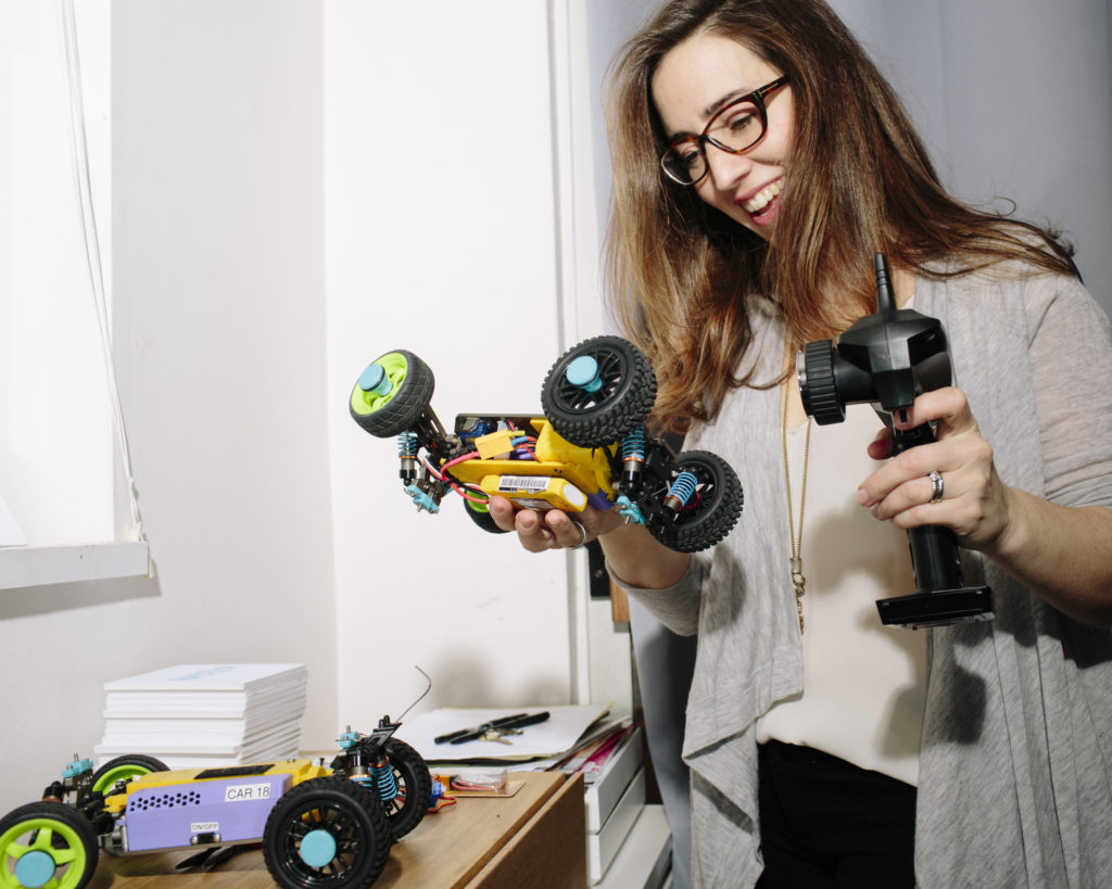 Abigail Edgecliffe-Johnson, founder of RaceYa - a tech start-up that creates customizable toy cars that teach children about science and engineering, works to fix and organize some of the cars at her home office on Monday, February 29, 2016. CREDIT: Adrienne Grunwald for The Wall Street Journal NYVENTURE